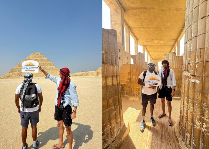 Two happy friends holding the Egypt Holiday Makers Sign during their visit to the Saqqara Step Pyramid site.