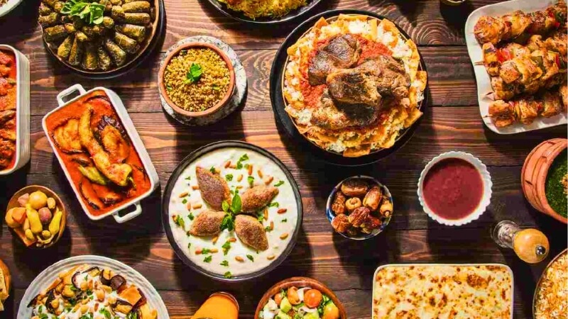 Traditional Ramadan food spread in Egypt with stuffed grape leaves and desserts.